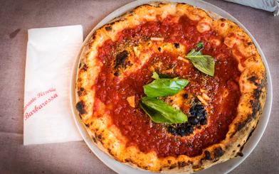 Pizza with tomato sauce and basil served at a restaurant in Capri, Italy.