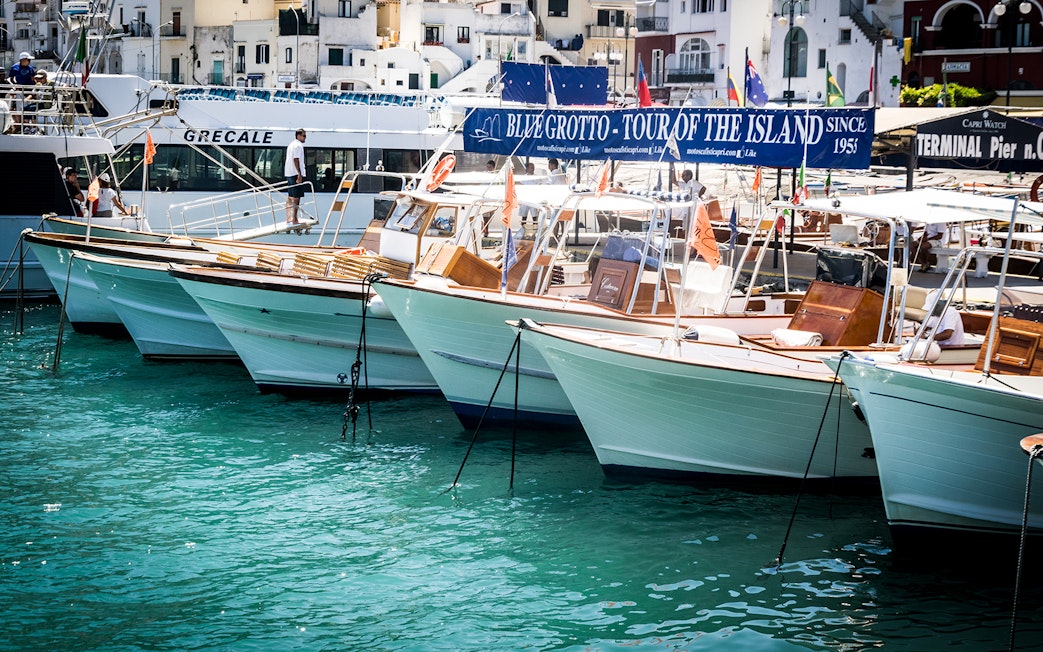 Boats docked at Capri port for Blue Grotto tour from Sorrento.