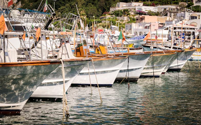 Boats docked at Capri harbor, Italy, for tours to Anacapri and Blue Grotto from Sorrento.