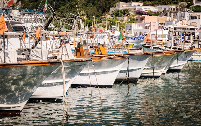Boats docked at Capri harbor, Italy, for tours to Anacapri and Blue Grotto from Sorrento.