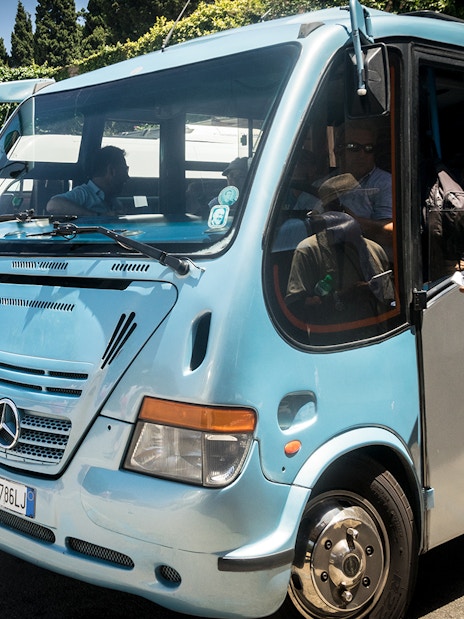 Tourists boarding a bus for Capri and Anacapri tour from Sorrento meeting point.