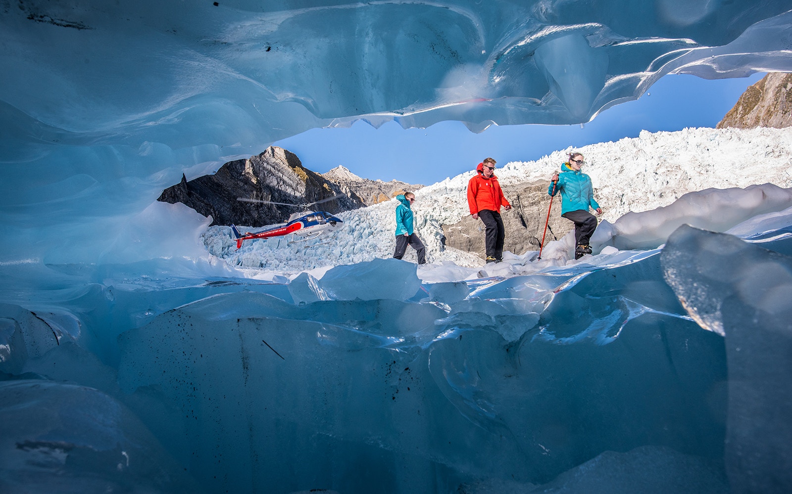 Helicopter and hikers on Franz Josef Glacier during expert guided heli-hike.