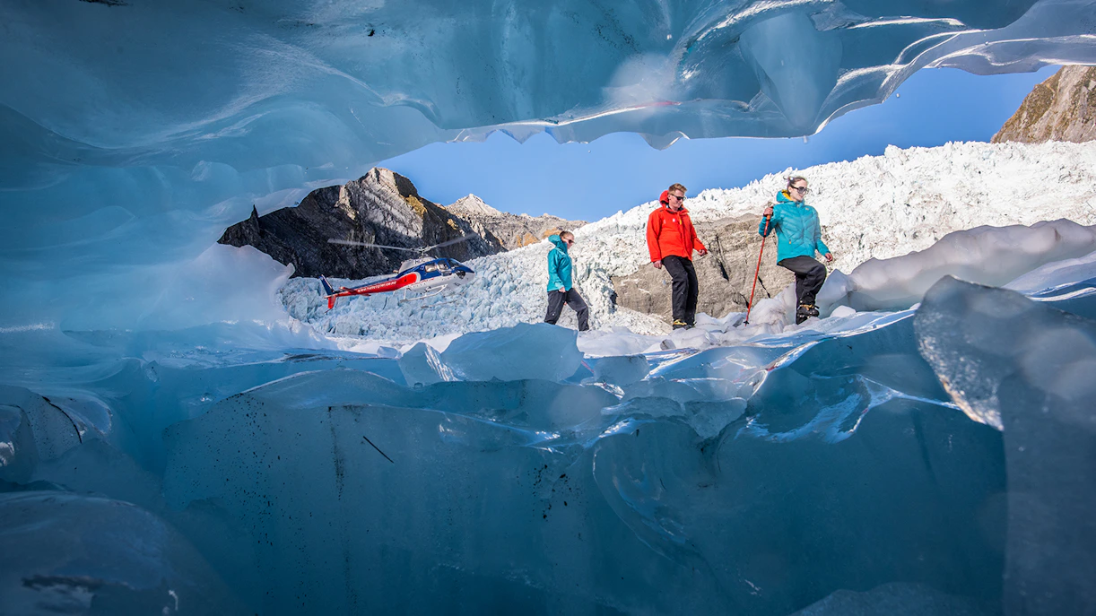 Helicopter and hikers on Franz Josef Glacier during expert guided heli-hike.