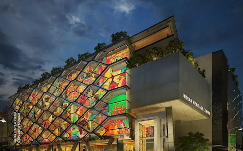 Indian Heritage Centre facade with vibrant mural and modern architecture at dusk.
