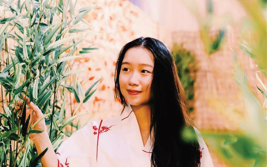 Person enjoying bamboo garden at Joya Onsen Cafe, Singapore.