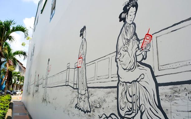 Street art mural of women in traditional attire with modern gadgets, Island Wanderer tour.