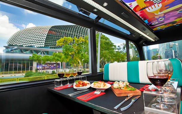 Dining setup inside Singapore GOURMETbus with view of Esplanade.
