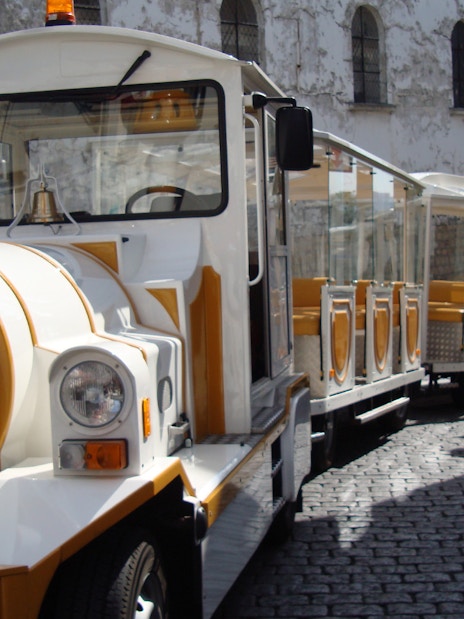 Tourist train on cobblestone street in Montmartre, Paris.