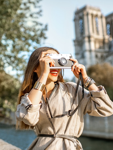 Tourist photographing Notre-Dame Cathedral in Paris.