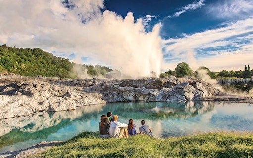 Visitors watching a geyser erupt at Te Puia geothermal park in Rotorua, New Zealand.