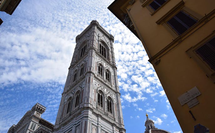 Giotto’s Bell Tower in Florence against a blue sky.