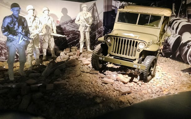 Torino Car Museum exhibit featuring a vintage military jeep and soldier mannequins.
