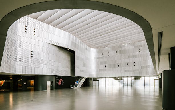Interior of Torino Car Museum with modern architecture and escalator.