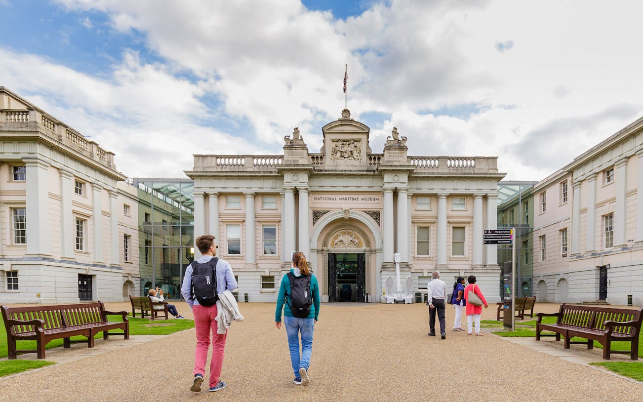 Visitors walking towards the National Maritime Museum in London.