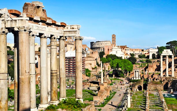 Ancient Roman Forum ruins with Colosseum in the background, Rome scooter tour.