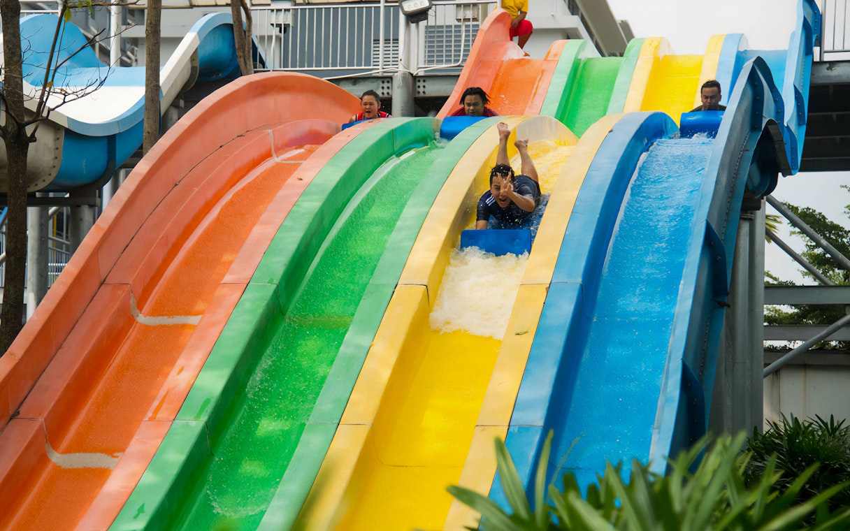 Water slides at Water World i-City Shah Alam with people enjoying the ride.