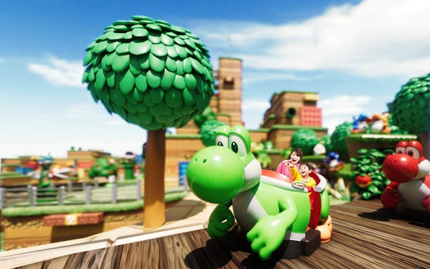 Visitors enjoying a Yoshi-themed ride at Universal Studios Japan.