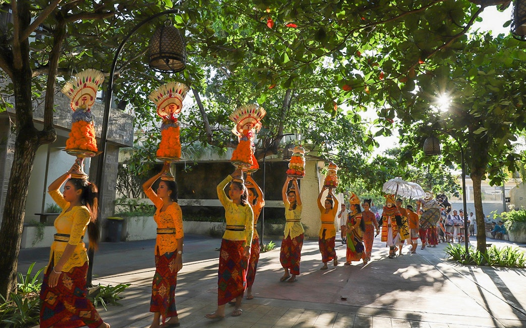 Traditional Balinese procession at Garuda Wisnu Kencana Culture Park, Bali.