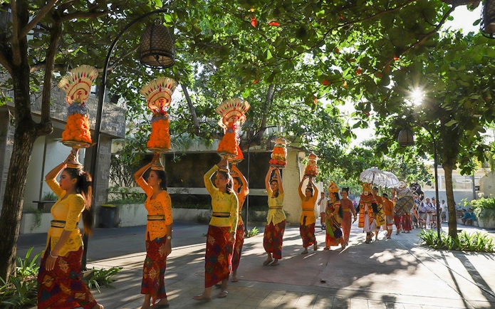 Traditional Balinese procession at Garuda Wisnu Kencana Culture Park, Bali.