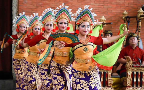 Balinese dancers performing at Garuda Wisnu Kencana Culture Park in Bali.