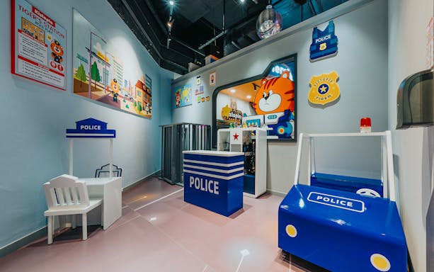 Kiztopia Club Jurong Point indoor play area with police-themed role-play setup.