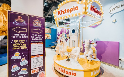 Kiztopia Club Jurong Point indoor carousel with colorful signage and seating area.