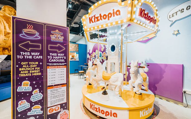 Kiztopia Club Jurong Point indoor carousel with colorful signage and seating area.