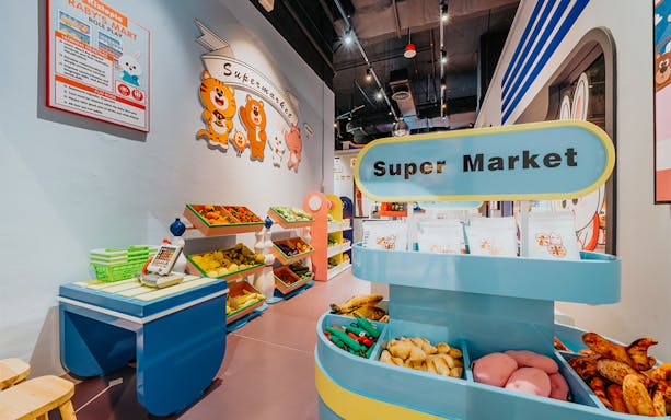 Children's play supermarket at Kiztopia Club Jurong Point with toy fruits and vegetables.