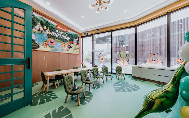 Kiztopia Club Punggol birthday room with decorated chairs and cartoon banner.