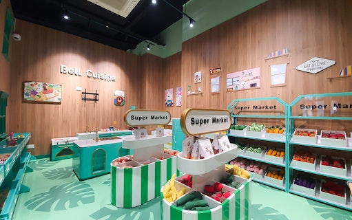 Play area with toy supermarket and kitchen at Kiztopia Club Punggol.