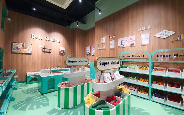 Play area with toy supermarket and kitchen at Kiztopia Club Punggol.