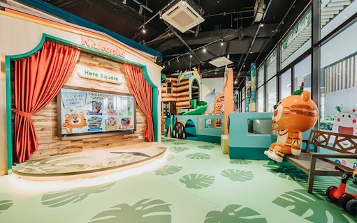 Kiztopia Club Punggol indoor playground with colorful slides and cartoon characters.