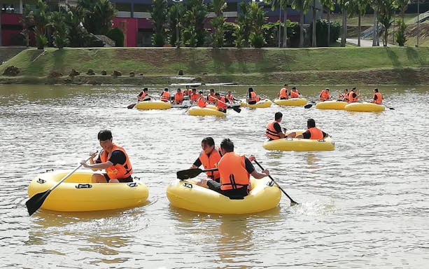 Visitors paddling in yellow rafts at Melaka Wonderland Water Theme Park.