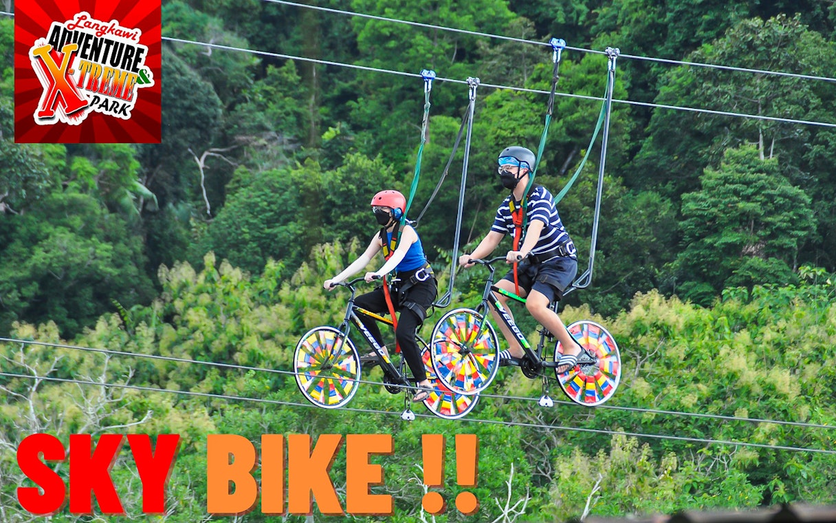 Two people riding sky bikes at Langkawi Adventure & Xtreme Park.