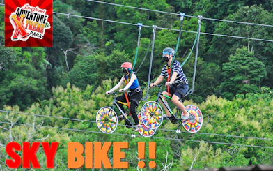 Two people riding sky bikes at Langkawi Adventure & Xtreme Park.