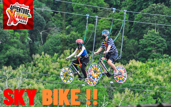 Two people riding sky bikes at Langkawi Adventure & Xtreme Park.