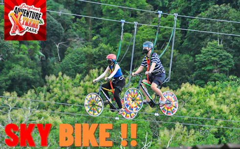 Two people riding sky bikes at Langkawi Adventure & Xtreme Park.