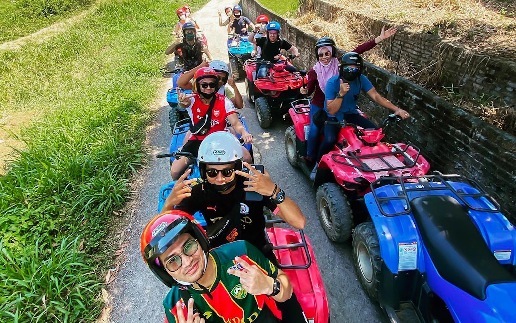 Group riding ATVs on a trail at Langkawi Adventure & Xtreme Park.