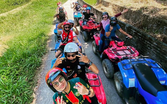 Group riding ATVs on a trail at Langkawi Adventure & Xtreme Park.