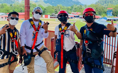 Visitors in safety gear at Langkawi Adventure & Xtreme Park, Malaysia.