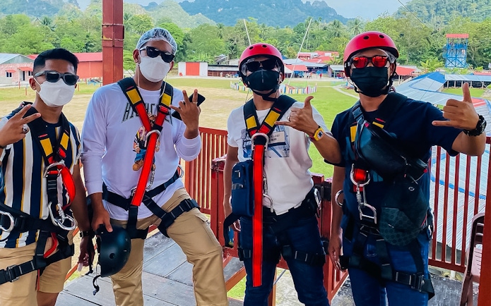 Visitors in safety gear at Langkawi Adventure & Xtreme Park, Malaysia.