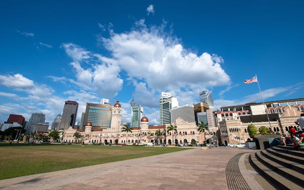 Sultan Abdul Samad Building with Kuala Lumpur skyline in the background.