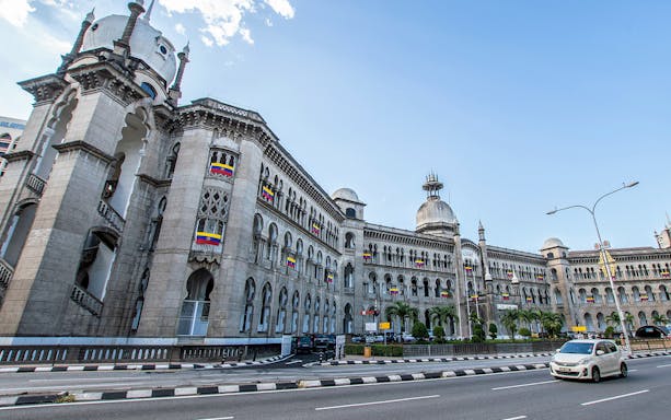 Kuala Lumpur Railway Station with colonial architecture on a sunny day.