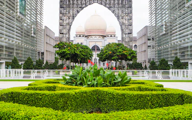 Kuala Lumpur architecture with lush gardens on a guided tour.