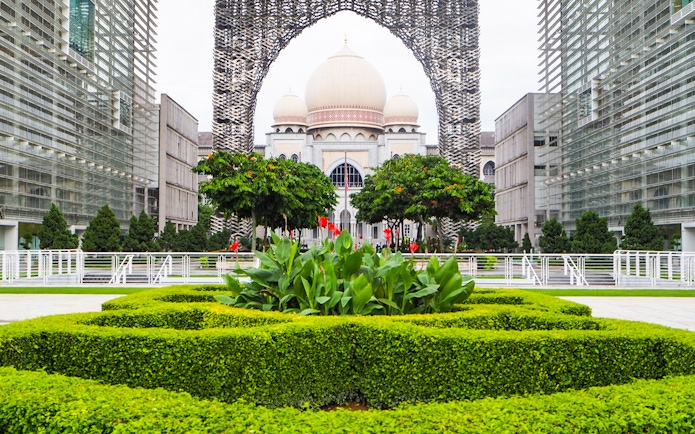 Kuala Lumpur architecture with lush gardens on a guided tour.
