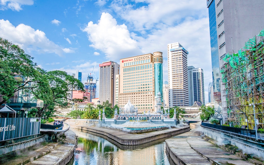 Kuala Lumpur skyline with Jamek Mosque by the river.