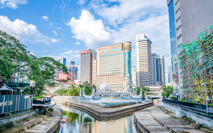 Kuala Lumpur skyline with Jamek Mosque by the river.