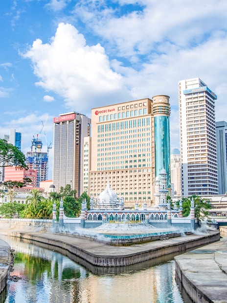 Kuala Lumpur skyline with Jamek Mosque by the river.