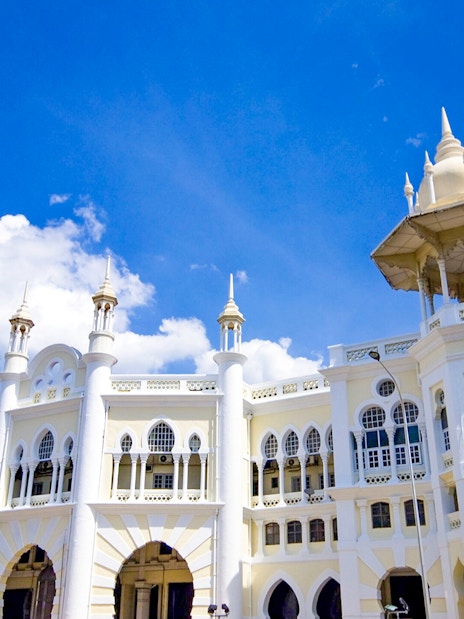 Kuala Lumpur Railway Station with Moorish architecture under blue sky.