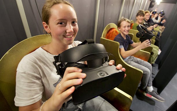 Visitors enjoying VR headsets at TimeRide Munich experience.